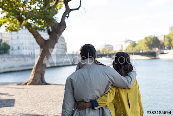 Affectionate couple walking along Seine River, Paris, France