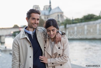 Affectionate couple walking along Seine River, Paris, France