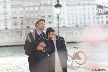 Affectionate couple walking along Seine River, Paris, France
