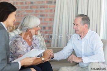Affectionate senior couple meeting with financial advisor