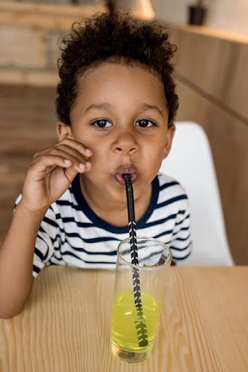 African american child drinking juice
