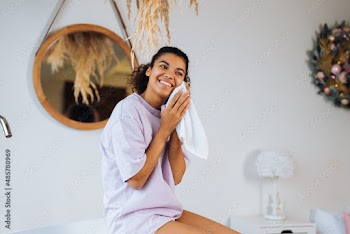 African american woman takes care of her skin in the bathroom