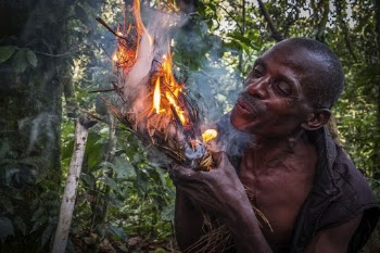 African man blowing on fire, | Free Photo - rawpixel