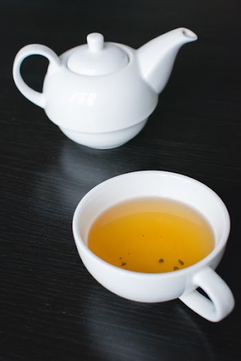 Afternoon black tea in a white teapot 