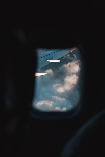 Aircraft Wing and Cloudy Sky
