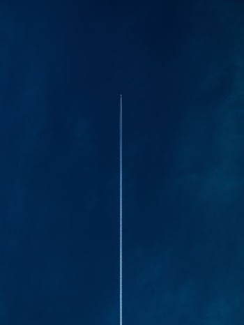 aircraft with line of air on blue sky