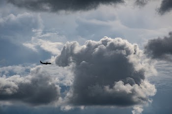Airplane Flying Near Gray Clouds