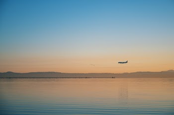 Airplane Flying over Body of Water