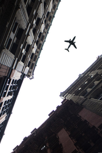 Airplane Under Cloudy Sky