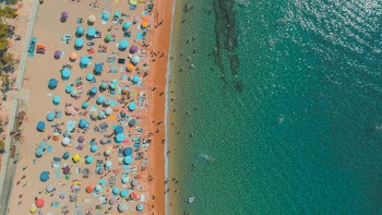 Amazing aerial view of sandy beach with sun umbrellas,  Bali, Indonesia