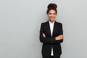 Amazing young african business woman standing over grey wall Free Photo