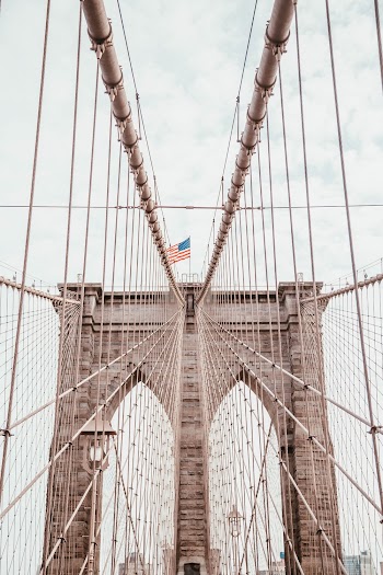 american flag on top of bridge