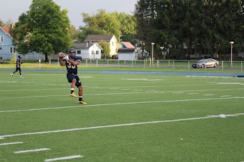 American Football Player Holding Ball