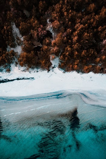 An aerial view of a beach on the small island of Bornholm. Taken minutes a few minutes after sunset during the blue hour with the DJI Mavic 2 Pro. 