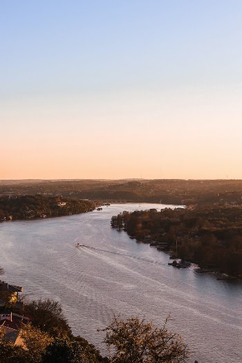 An Aerial View of a River Surrounded with Green Trees