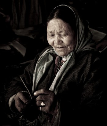 an elderly person Wearing White Headscarf Knitting