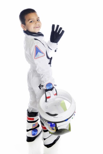An elementary aged 'astronaut' turning and waving as he walks away...