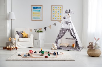 an empty children's playroom with tent and  toy railway
