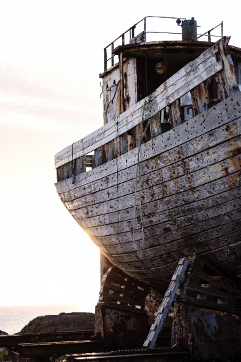 An old boat on the docks in Akranes, Iceland. Rusting and rotting in the Icelandic elements, it's still very photogenic and easy to access. A quick walk or drive from the center of town.