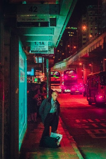 An old man waiting for his ride to come