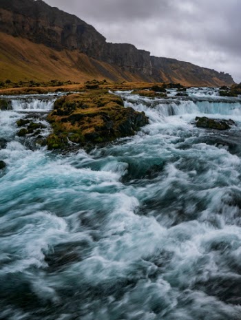 An unnamed cascade of glacial blue water in Iceland. 