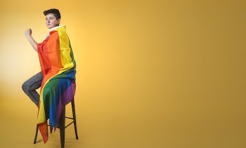 Androgynous Person Wrapped In Rainbow Pride Flag
