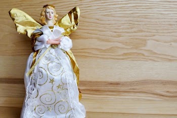 Angel Ceramic Figurine on Beige Wooden Surface
