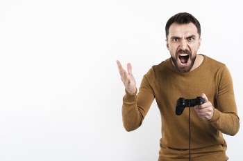 Angry man holding game controller Free Photo