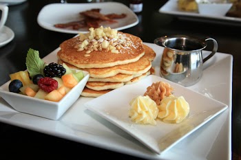 apple pancakes with maple butter and fresh fruit for breakfast