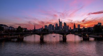 Arch Bridge Near Buildings during Golden Hour