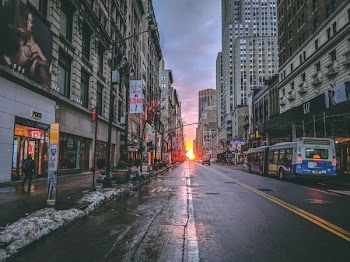 architectural photography of blacktop road surrounded by buildings during daytime