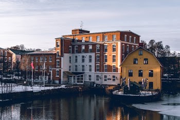 Architectural Photography of Brown and White Building Near Body of Water