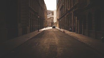 architectural photography of vehicle between two buildings
