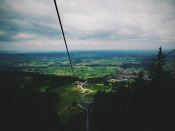 Areal View of Green Fields Under Grey Sky
