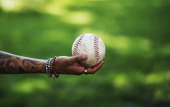 Arm Reaches Out Holding Softball