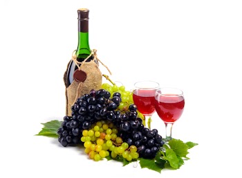 Arrangement of grapes with a bottle of wine and glasses