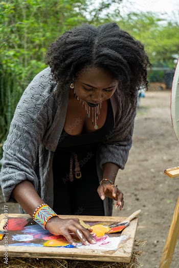 artist mixing paint with her hands