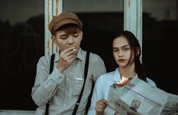 Asian Couple Standing Beside Window