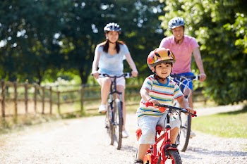 Asian Family On Cycle Ride Countryside
