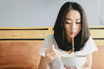 Asian Girl Eats Instant Noodle