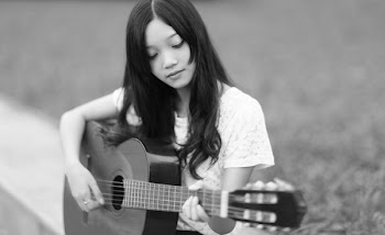 Asian girl play guitar in black and white