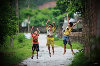 Asian kid jump up in the rain