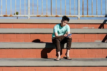 Asian teen boy, listening to music and using… | Free stock photo | High Resolution image
