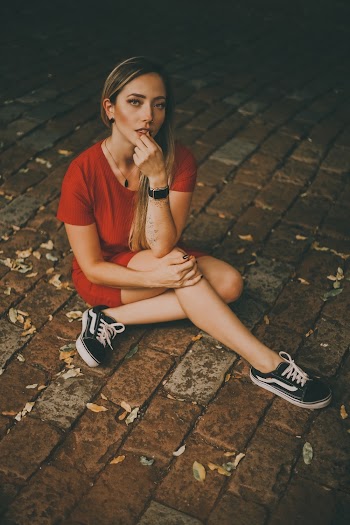 asian woman sitting on bricks