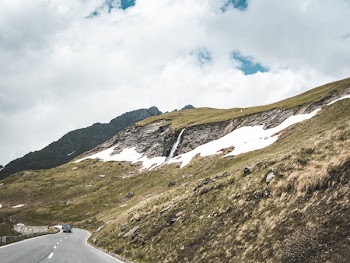Asphalt Road Beside Green Hills at Daytime