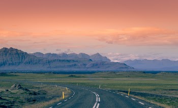 Asphalt Road Between Grass Field during Golden Hour
