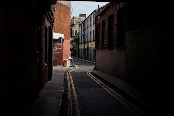 asphalt road by structures
