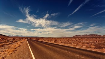 Asphalt Road Under White Clouds