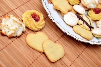 Assorted Baked Cookies on White Ceramic Plate on Top of Brown Bamboo Mat