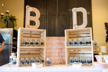 Assorted Clear Glass Jars in Wooden Racks